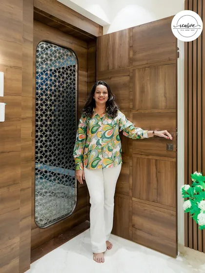 I love creating welcoming entrances. Here I am, standing by one of our custom-designed main doors.