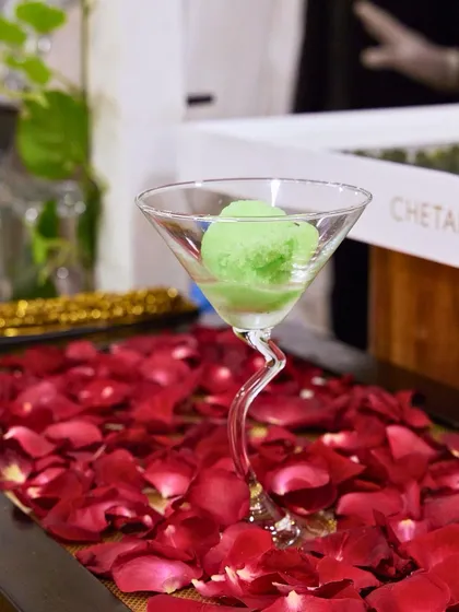 A scoop of refreshing green sorbet served in a whimsical martini glass. This light and palate-cleansing dessert is perfect after a rich meal.