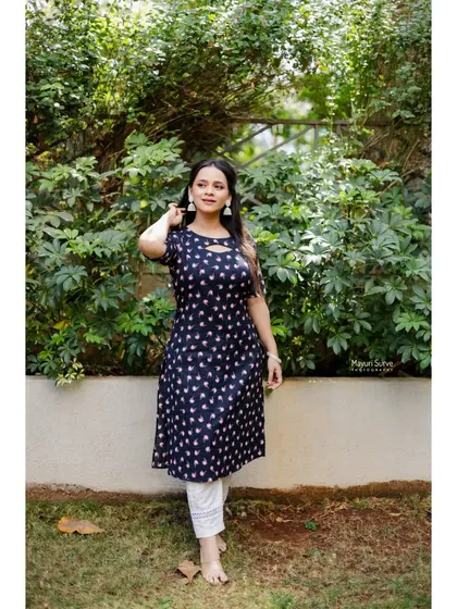 A full-length portrait in a garden setting. This shot shows the model in a casual and comfortable pose, perfect for showcasing a relaxed and natural side.