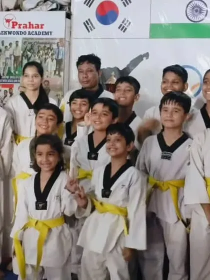 A happy group of our yellow belt students with their coaches. We ensure our beginners feel welcome and motivated.