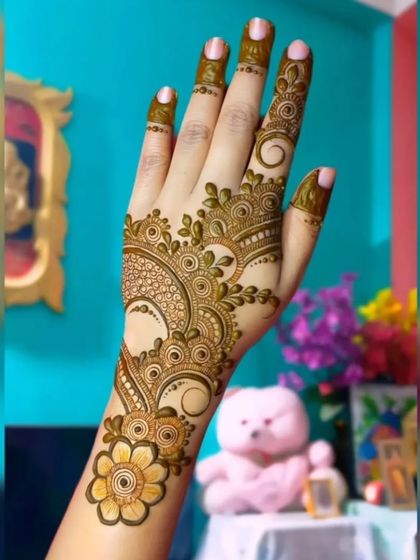 A simple yet beautiful floral design on the back of the hand. This style is perfect for someone who wants an elegant touch of henna without the full coverage of traditional mehendi.