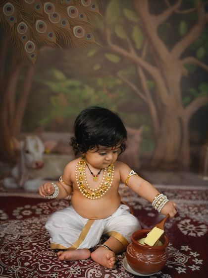 Little Krishna enjoying his pot of butter. Themed shoots like this allow for fun, story-telling images that go beyond a simple portrait.