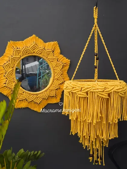 A vibrant yellow macramé mirror and matching chandelier-style plant hanger. This set is perfect for adding a bold and sunny statement to your decor.