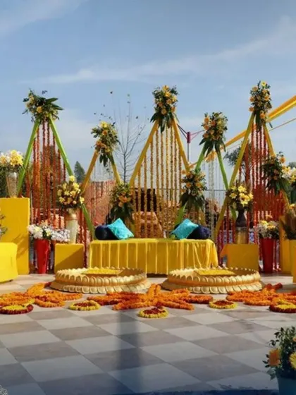 We are equipped to handle large-scale outdoor lawn decorations for Haldi functions. This setup features our geometric pyramid backdrops, multiple seating areas for guests, and coordinated floral arrangements across the venue.