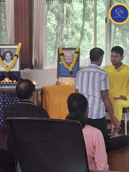A devotee kneels to receive a blessing during the purification ceremony. This act of humility and receptivity is a physical gesture that reinforces our inner intention to be purified and guided by the guru.