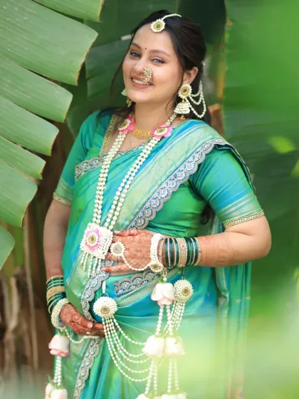 Celebrating the beautiful journey of motherhood. This expecting mother looks serene in our bespoke floral set for her dohale jevan. We use only the gentlest organic flowers, ensuring they are safe and comfortable for the mom-to-be.