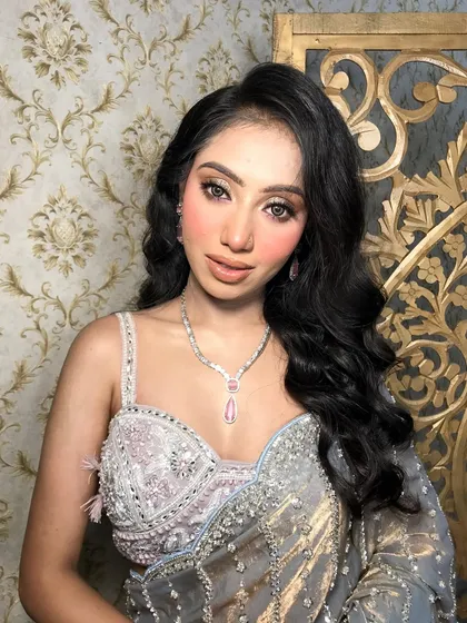A frontal view of the client, her pink diamond jewelry adding a soft, feminine touch.