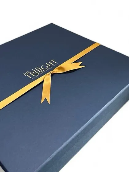For the luxury real estate brand 'The Trilight', we created this elegant gift box with their logo foil-stamped in gold. The finishing touch is a simple gold ribbon, because we believe presentation is just as important as the gift inside.