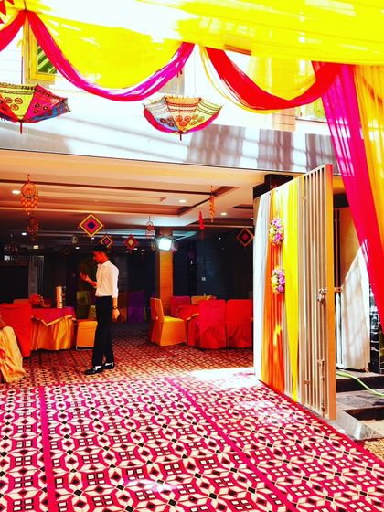 A view from the entrance of a decorated hall, showing the seamless transition from the outdoor tent to the indoor event space.