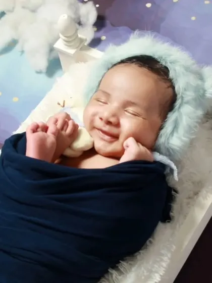 A heart-melting smile from a sleeping newborn. We captured this precious moment during an in-home newborn session, showing just how sweet and peaceful they are in their first few weeks.