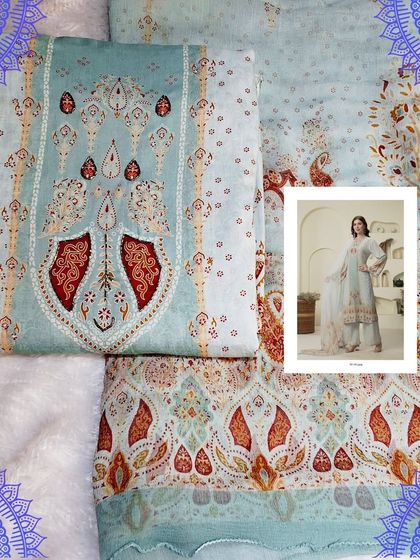 This light blue muslin dress material features a traditional print in shades of red and orange. It's a perfect choice for creating a graceful and comfortable ethnic outfit.