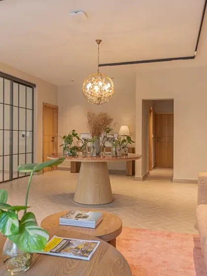 A closer view of the office reception area, highlighting the biophilic design elements. We incorporated natural materials and plants alongside our custom wooden tables to create a serene atmosphere.