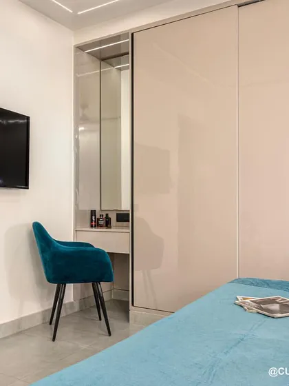 This bedroom design includes a hidden dressing table within the sliding wardrobe unit. It’s a perfect space-saving solution that keeps the room looking tidy and uncluttered.