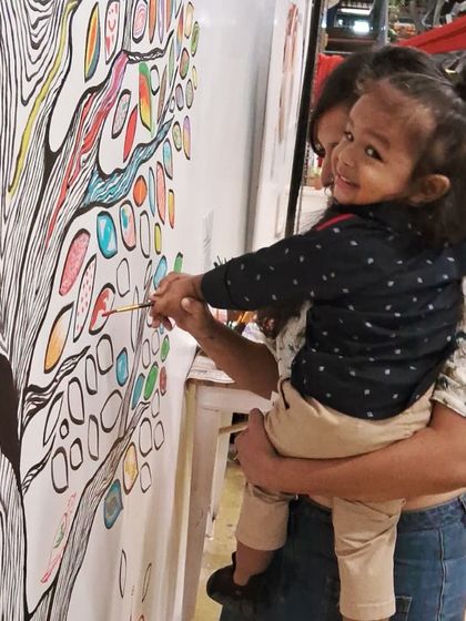 The 'Mosaic of Us' tree mural was a collaborative piece created during the Hearth Summit. I painted the outline, and attendees brought it to life by coloring in the leaves. It stands as a beautiful symbol of how individual contributions create a vibrant, collective whole.