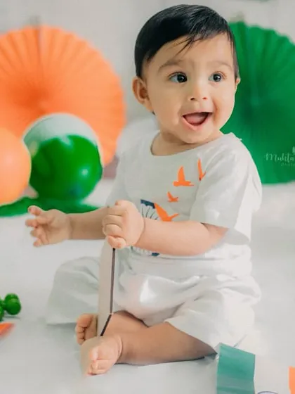 Full of excitement and happiness. This little boy loved playing with the flags and balloons during his session.
