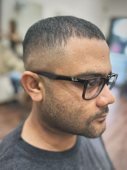 A side profile of a classic skin fade crew cut. Notice how the fade is graduated perfectly to complement the head shape. This is a fundamental style we master in my workshops.