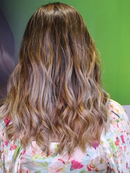 The "after" result. A beautiful, wavy blonde balayage that completely changes the look.