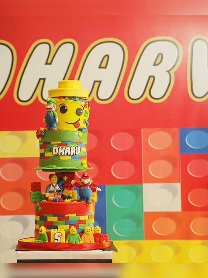 A fantastic multi-tiered LEGO-themed cake, complete with colorful bricks and characters, was the star of Dharv's 5th birthday.