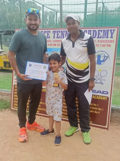 One of our champions receiving his award from the coaches. We make sure to recognize and celebrate every player's hard work.