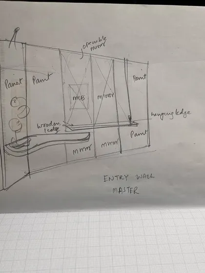 A detailed sketch for the entry wall of a master bedroom. This drawing outlines the placement of mirrors, paint finishes, and a custom wooden console, serving as a crucial communication tool for our team and artisans.