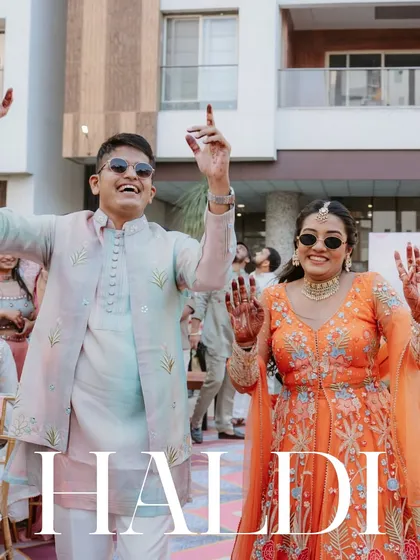 The grand entrance to their Haldi. With sunglasses on and hands in the air, this couple is ready to dance their way into their new life together.