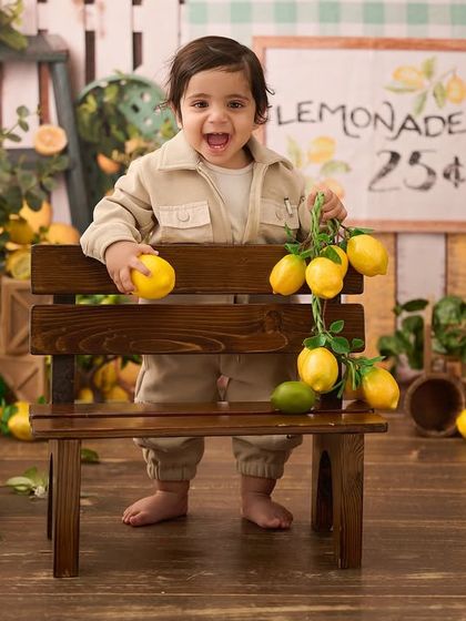 Full of excitement at the lemonade stand. We capture the energy and personality of your baby as they interact with our creative sets.