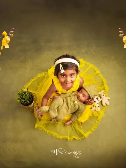 A big sister's gentle welcome. This overhead shot captures the tender beginning of a lifelong bond between siblings. I carefully pose newborns with their older brothers and sisters to create sweet, memorable images of your growing family.