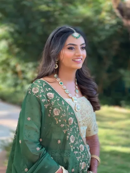 The bride's joyful smile is complemented by her romantic hairstyle, which is perfect for a daytime wedding ceremony or reception.