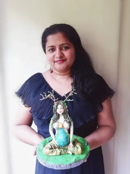 Here I am holding my finished Mother Earth sugar sculpture. It was a challenging and rewarding project, and I love teaching others the skills to create their own works of art.