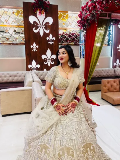 A series of photos of my happy client looking absolutely stunning in a heavily embroidered silver-grey lehenga at her reception. She owned the look completely!