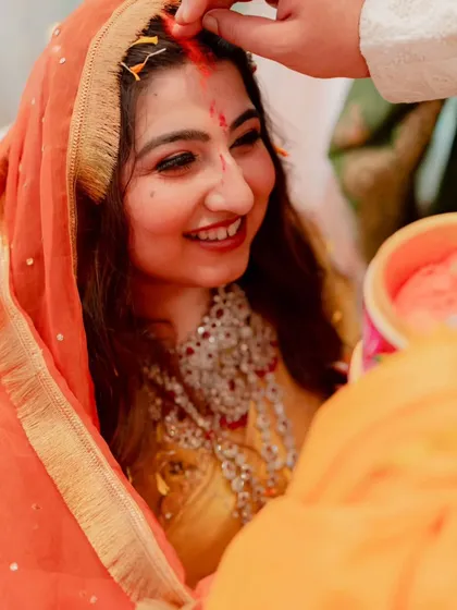 A precious moment from the wedding ceremony. The bride's makeup is designed to be long-lasting and picture-perfect, with a focus on glowing skin and beautifully defined eyes that radiate happiness.