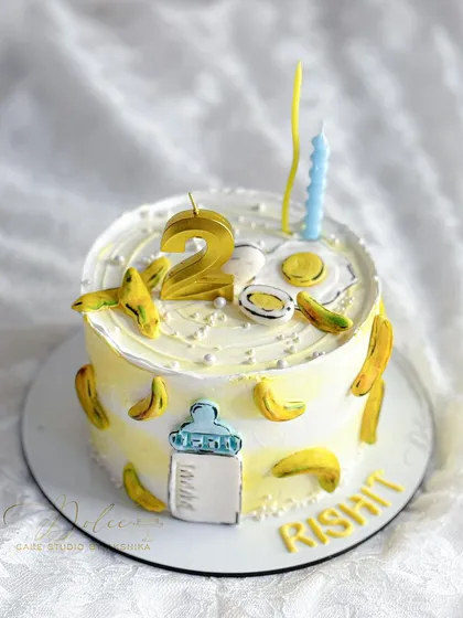 Another view of the milk, egg, and banana themed cake. The handcrafted fondant elements make this a truly unique and memorable birthday cake.