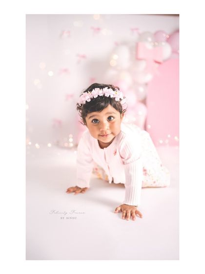 A sweet crawling shot from a pink bow-themed first birthday session. Capturing these milestones is so important.