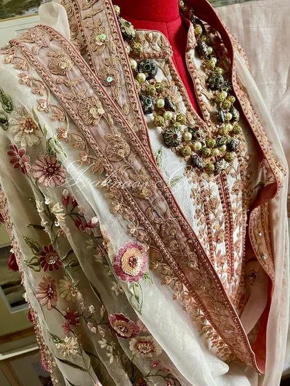 A mannequin shot of the suit, styled with a necklace to show its festive readiness.