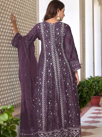 A stunning purple Anarkali with intricate thread, zari, and sequence work. The flowing silhouette and rich color make it a perfect choice for a sangeet or reception.