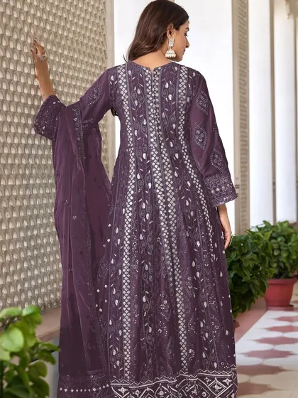 A stunning purple Anarkali with intricate thread, zari, and sequence work. The flowing silhouette and rich color make it a perfect choice for a sangeet or reception.