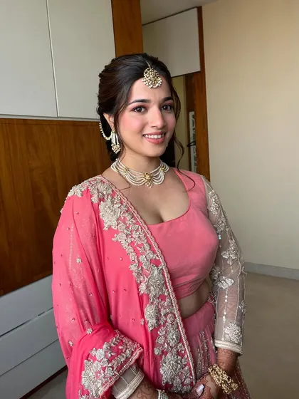 This bride glowed in a dreamy baby pink lehenga for her Day 3 event. We kept the look natural and fresh with soft pink tones, a delicate braid, and loose front strands.