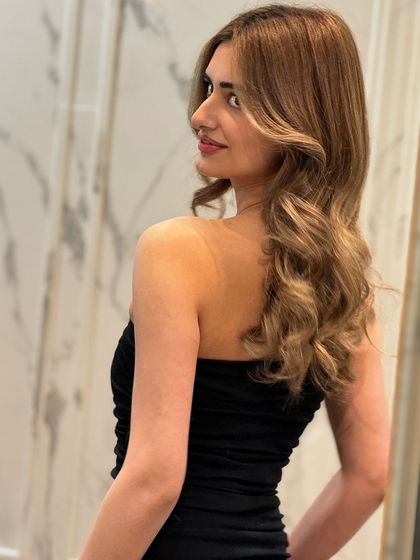 A side view of the blonde transformation, highlighting the beautiful layers and rich color.