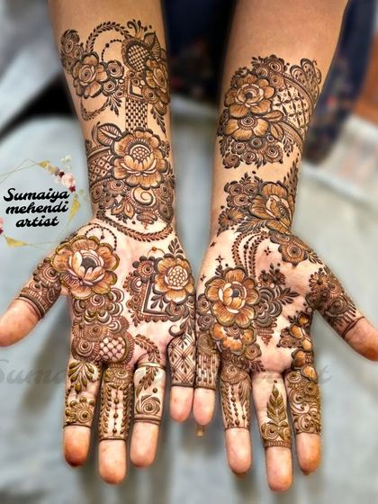 A beautiful floral henna design with a mix of large and small flowers. The negative space around the flowers on the palm really makes them stand out.