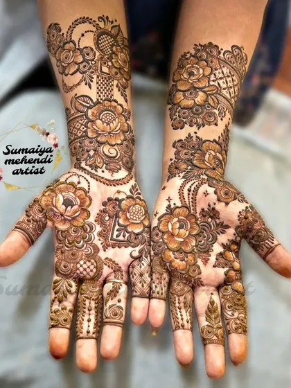 A beautiful floral henna design with a mix of different flowers and leaves.
