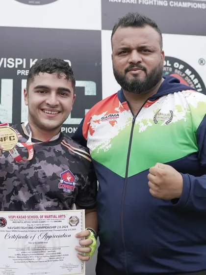 Me with Vraj after he secured a gold medal at the Navsari Fighting Championship. A proud moment for a dedicated fighter.