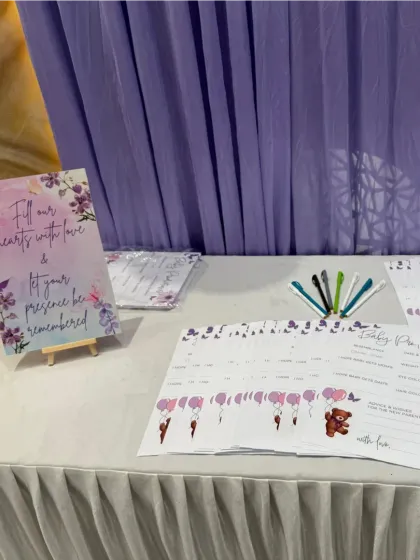 A guest book station for a baby shower, designed to collect heartfelt wishes. The setup includes a lovely sign and custom-printed cards for guests to write messages, ensuring the parents have cherished memories to look back on.