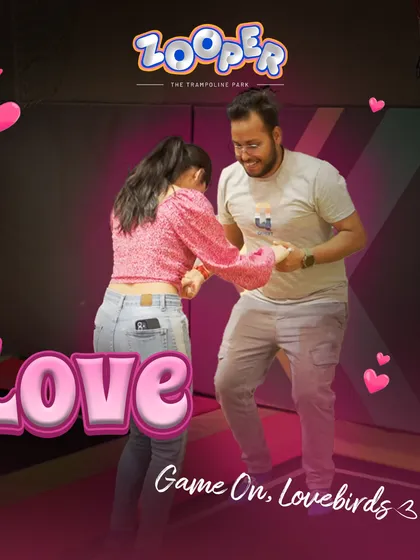 Game on, lovebirds. A couple shares a playful moment, ready for a date filled with adventure.