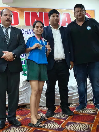 A young female champion from my team receiving her medal. It's inspiring to see such dedication and skill at a young age.