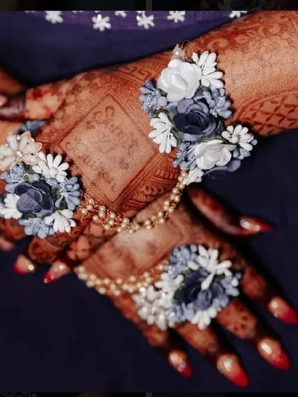 A close-up of the rich henna stain, which provides a beautiful backdrop for the floral hand jewelry.