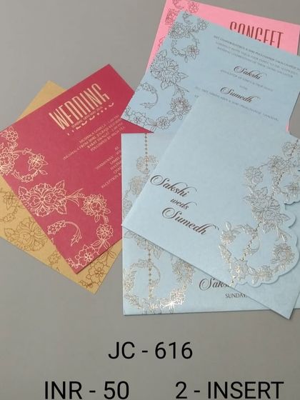 This budget-friendly invitation set comes in multiple bright colors like pink, blue, and yellow. The silver floral die-cut adds a touch of elegance to the simple design.