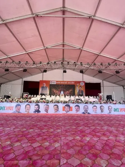 The stage setup for a major political event. We construct large, elevated platforms complete with professional lighting trusses, sound systems, and branding banners to meet the specific needs of public functions.