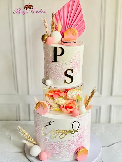 Another take on my popular engagement cake design. This version features pink stenciling, a floral separator, and accents of macarons and dried wheat for a rustic-chic look.