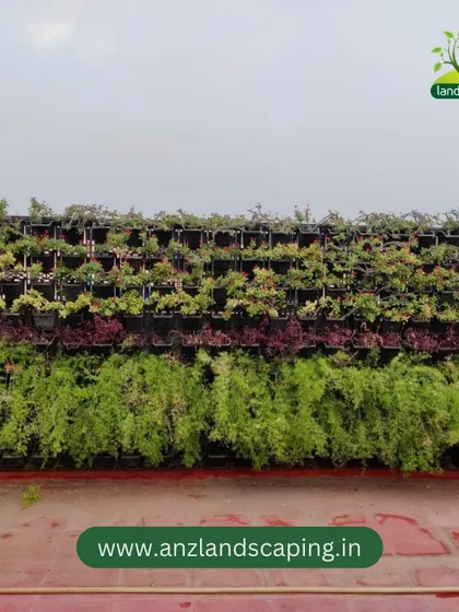 This large-scale vertical garden was installed on a rooftop, creating a massive green facade. The design uses bands of different plant types, including flowing asparagus ferns and colorful foliage, to create a striped, textured pattern.