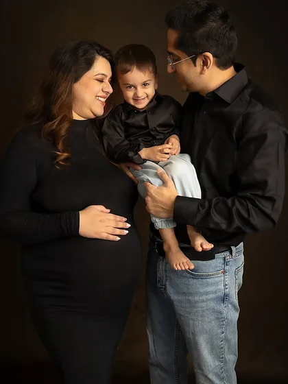 A beautiful family pose, capturing the connection and love between parents and their child during a maternity session.